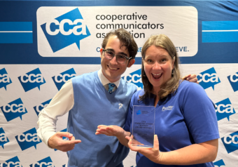 Levi Smith and Megan McKoy-Noe hold an award from CCA.