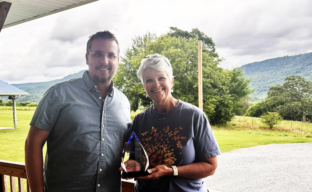 Andy Johns and Carrie Huckeby with award