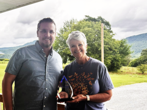 Andy Johns and Carrie Huckeby with award