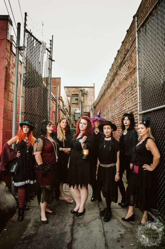Ghost tour storytellers pose in an alley
