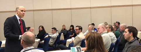 man speaking at conference